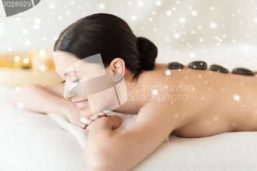 Image of woman in spa salon with hot stones