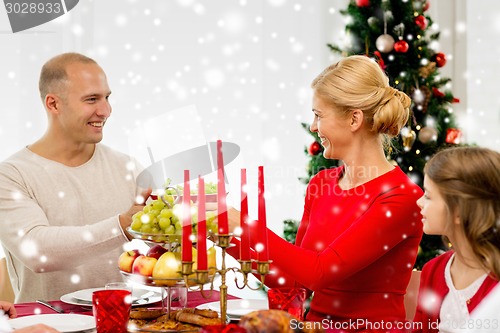 Image of smiling family having holiday dinner at home