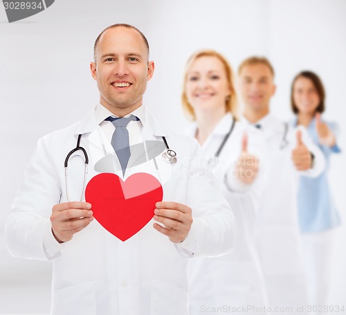 Image of smiling male doctor with red heart and stethoscope