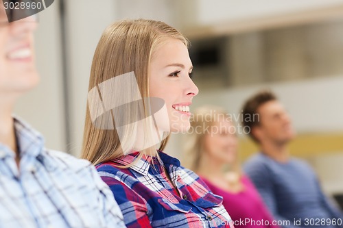 Image of group of smiling students in lecture hall