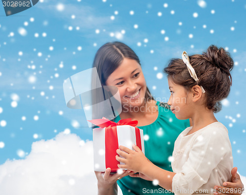 Image of happy mother and child girl with gift box