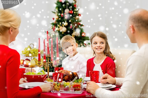 Image of smiling family having holiday dinner at home