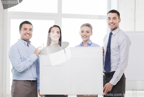 Image of business team in office with white blank board