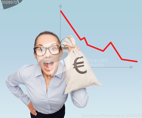 Image of businesswoman holding money bag with euro