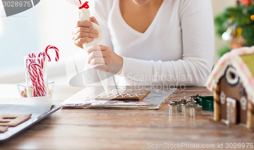 Image of close up of woman making gingerbread houses