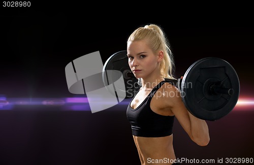 Image of sporty woman exercising with barbell