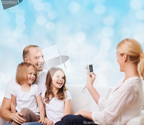 Image of happy family with camera at home