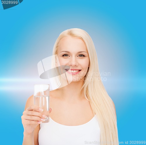 Image of young smiling woman with glass of water