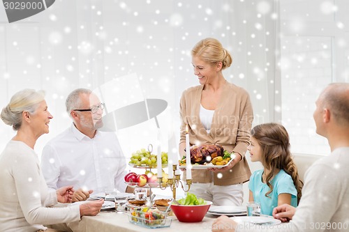 Image of smiling family having holiday dinner at home