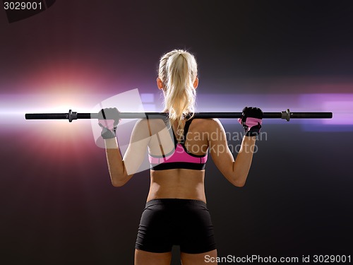 Image of sporty woman exercising with barbell