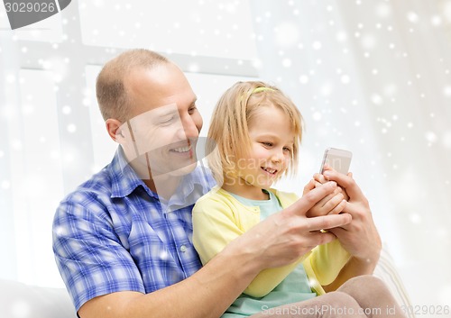 Image of happy father and daughter with smartphone