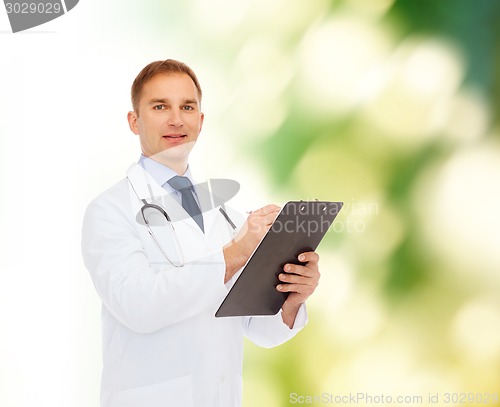 Image of smiling male doctor with clipboard and stethoscope