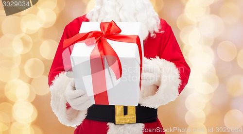 Image of man in costume of santa claus with gift box