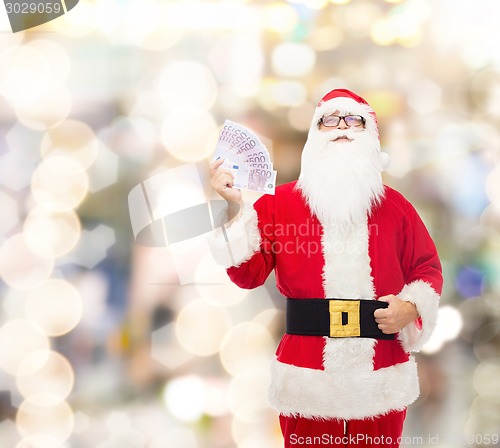 Image of man in costume of santa claus with euro money