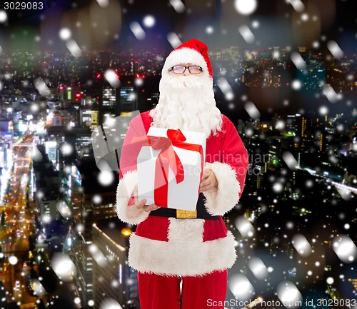 Image of man in costume of santa claus with gift box