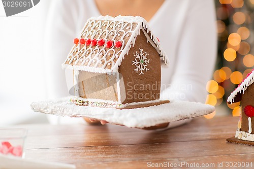 Image of close up of woman showing gingerbread house