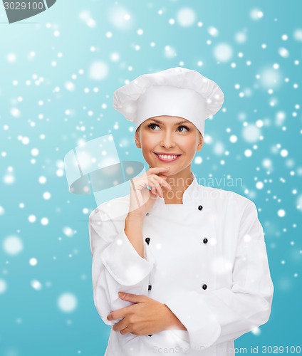 Image of smiling female chef dreaming