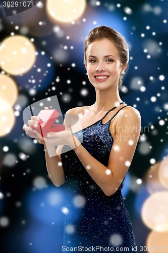 Image of smiling woman holding red gift box