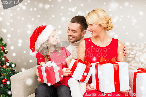 Image of smiling family holding many gift boxes