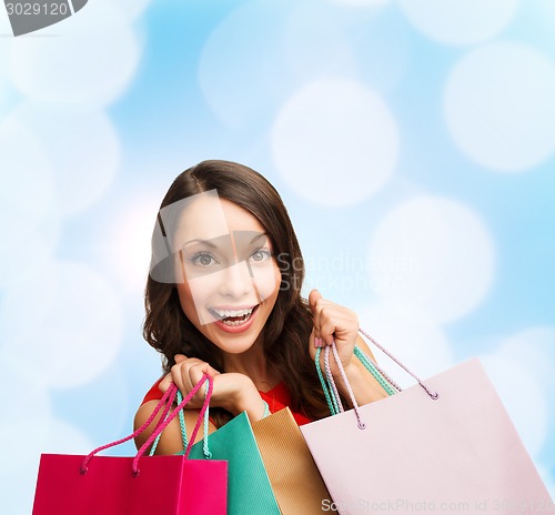 Image of smiling woman with colorful shopping bags