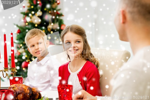 Image of smiling family having holiday dinner at home