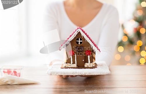 Image of close up of woman showing gingerbread house