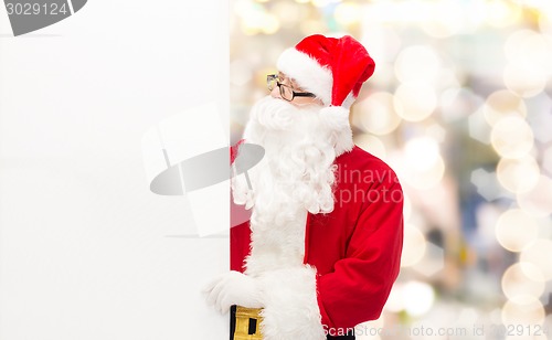 Image of man in costume of santa claus with billboard