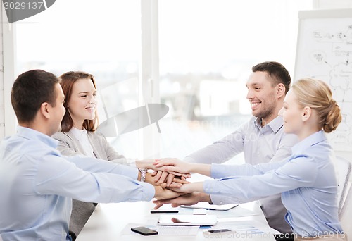 Image of business team celebrating victory in office