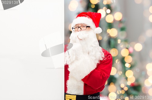 Image of man in costume of santa claus with billboard