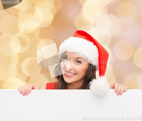 Image of woman in santa helper hat with blank white board
