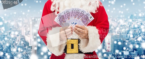 Image of close up of santa claus with euro money