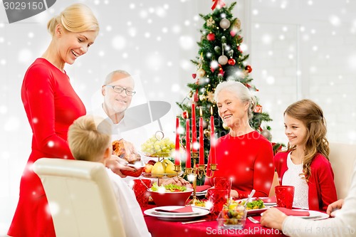 Image of smiling family having holiday dinner at home