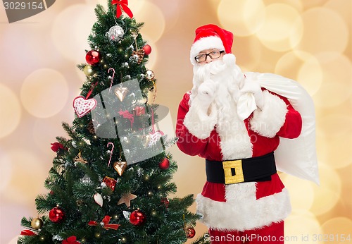 Image of santa claus with bag and christmas tree