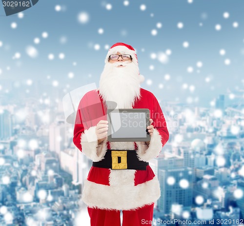 Image of man in costume of santa claus with tablet pc
