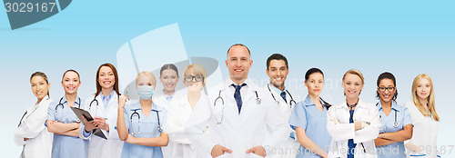 Image of group of smiling doctors with clipboard