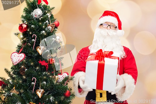 Image of man in costume of santa claus with gift box