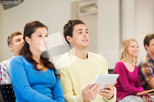 Image of group of smiling students with tablet pc