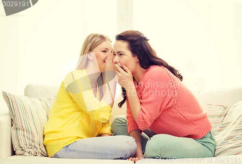 Image of one girl telling another secret