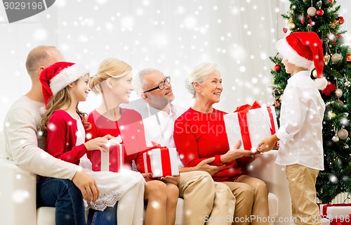 Image of smiling family with gifts at home