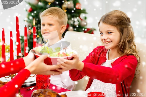 Image of smiling family having holiday dinner at home