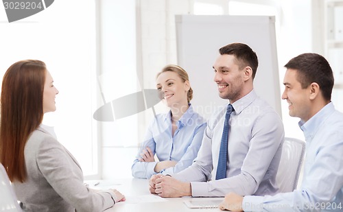 Image of smiling businesswoman at interview in office