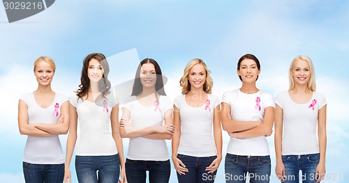 Image of smiling women with pink cancer awareness ribbons