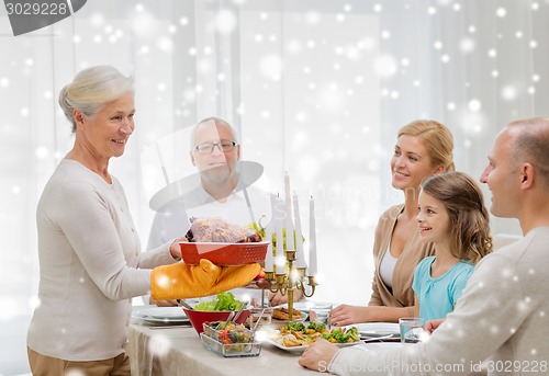 Image of smiling family having holiday dinner at home