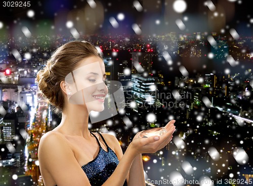 Image of smiling woman in evening dress with diamond