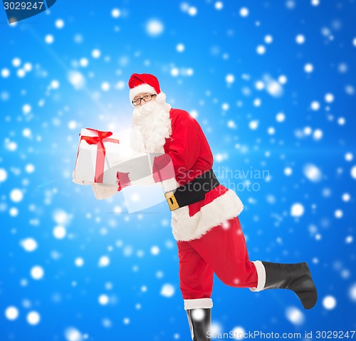 Image of man in costume of santa claus with gift box