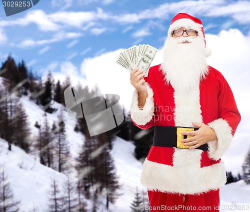 Image of man in costume of santa claus with dollar money