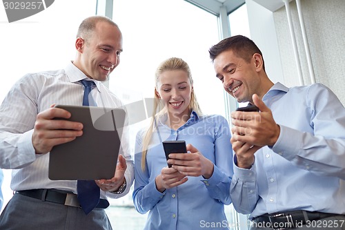 Image of business people with tablet pc and smartphones