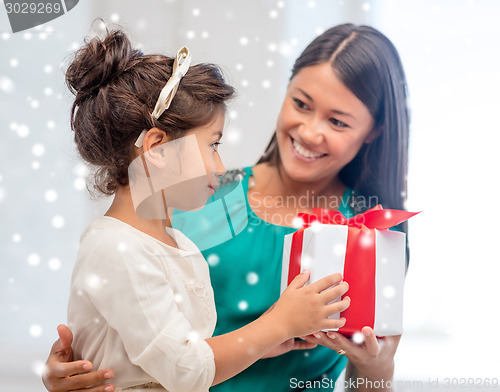 Image of happy mother and child girl with gift box