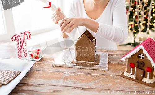 Image of close up of woman making gingerbread houses