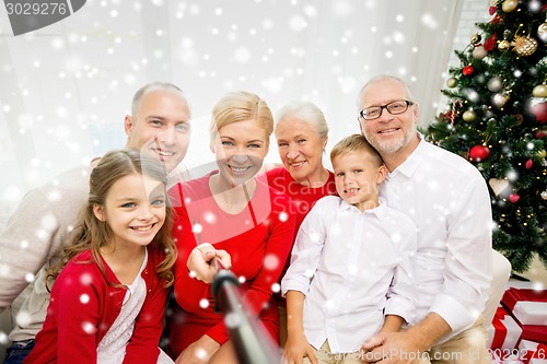 Image of smiling family making selfie at home